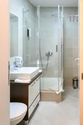 a bathroom with a sink and a shower at MV Monogram in Inđija
