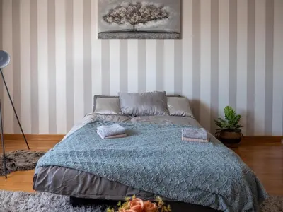 a bedroom with a bed with a blue blanket at GOFD Apartman in Belgrade
