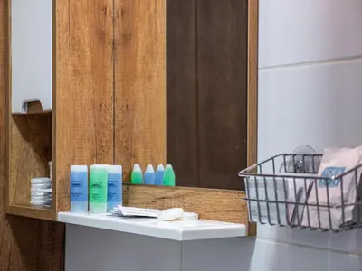 a shelf with two bottles of soap and a mirror at GOFD Apartman in Belgrade