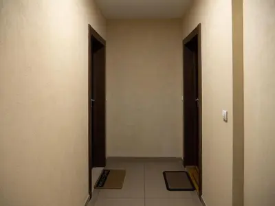 an empty hallway with two doors and a tile floor at GOFD Apartman in Belgrade