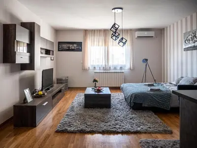 a living room with a couch and a table at GOFD Apartman in Belgrade