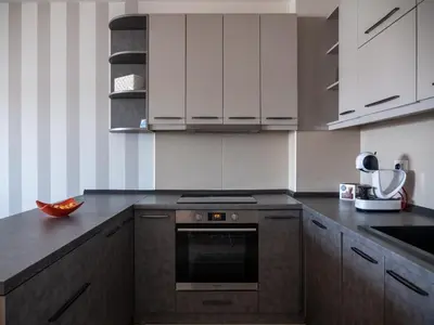 a kitchen with white cabinets and an oven at GOFD Apartman in Belgrade