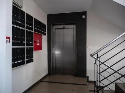 a hallway with a door in a building with wine racks at GOFD Apartman in Belgrade