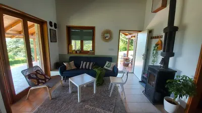 a living room with a couch and a stove at Hacienda Guster in Ritopek