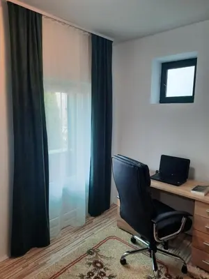 a office with a chair and a desk and a window at Vila Sava in Jarak