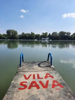 a dock with a sign that reads ville a saav on a lake at Vila Sava in Jarak