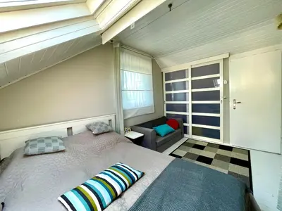 a bedroom with a large bed and a couch at Avala Sunset Apartments in Belgrade