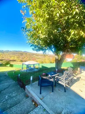 a picnic table and a gazebo under a tree at Avala Sunset Apartments in Belgrade