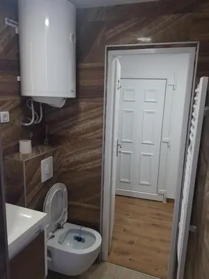 a bathroom with a toilet and a sink and a door at studio skadarlija in Belgrade