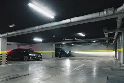 a parking garage with two cars parked in it at Hotel LoRa in Belgrade