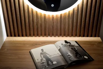 a book sitting on a table under a lamp at Hotel LoRa in Belgrade