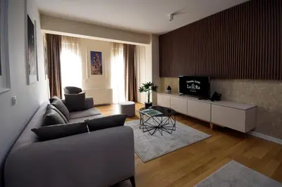 a living room with a couch and a tv at Hotel LoRa in Belgrade