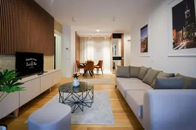 a living room with a couch and a tv at Hotel LoRa in Belgrade