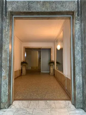 an empty hallway with two potted plants in a building at City centre apartment in Belgrade