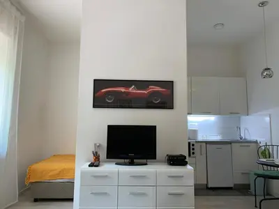 a living room with a television on a white wall at City centre apartment in Belgrade