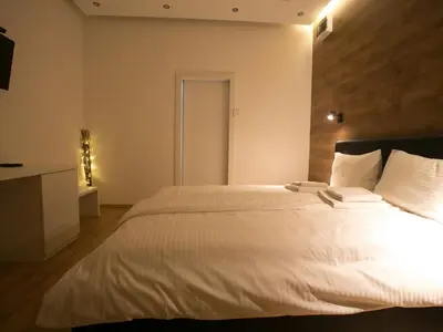 a bedroom with a large bed with white sheets at Studio 138 in Belgrade