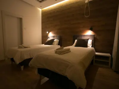 two beds in a hotel room with towels on them at Studio 138 in Belgrade