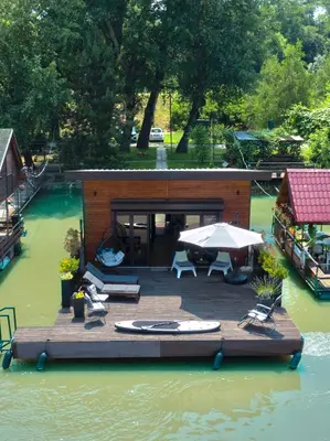 a small house on a dock in the water at Beach House Belgrade in Belgrade
