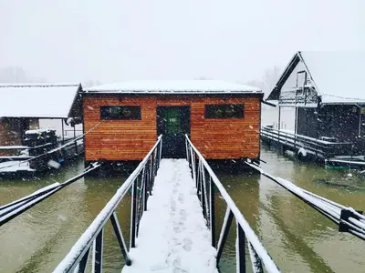 a building on a bridge in the snow at Beach House Belgrade in Belgrade