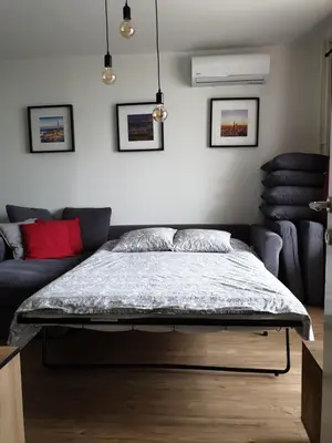 a bedroom with a bed and a couch at TiTo LuX in Belgrade