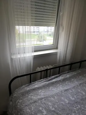 a bedroom with a bed and a window at TiTo LuX in Belgrade