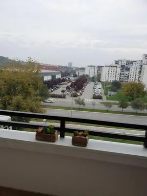 a balcony with two plants sitting on a ledge at TiTo LuX in Belgrade