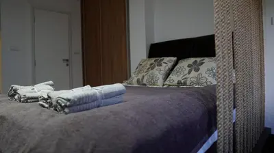 a bed with two towels on top of it at Vilovski in Vračar (historical)