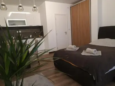 a bedroom with a bed with towels on top of it at Vilovski in Vračar (historical)