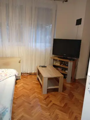 a living room with a tv and a coffee table at Nataly Apartment in Belgrade