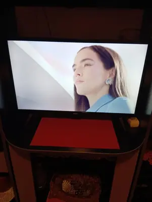 a television screen with a picture of a woman at Nataly Apartment in Belgrade