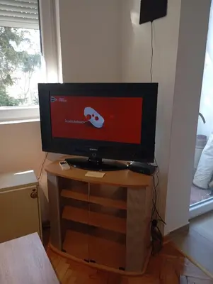 a television on a table in a room at Nataly Apartment in Belgrade