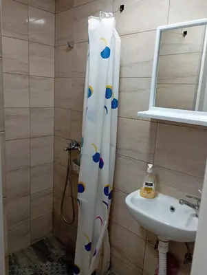 a bathroom with a shower curtain and a sink at Nataly Apartment in Belgrade