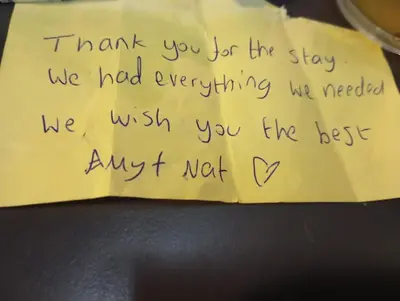 a piece of writing on a yellow piece of paper at Nataly Apartment in Belgrade