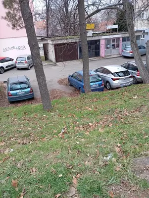 a group of cars parked in a parking lot at Nataly Apartment in Belgrade