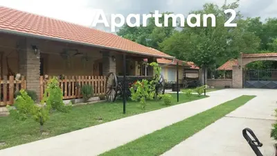 a house with a garden in front of it at Rita Apartman & Studio in Zrenjanin