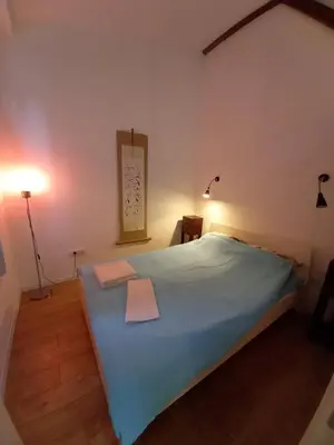 a bedroom with a large bed with two towels on it at Brickloft in the heart of Belgrade in Belgrade