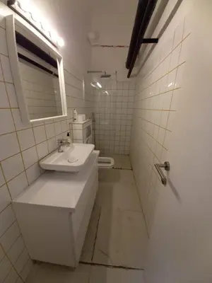 a white bathroom with a sink and a mirror at Brickloft in the heart of Belgrade in Belgrade
