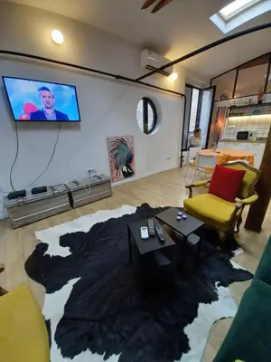 a living room with a tv on a wall at Brickloft in the heart of Belgrade in Belgrade