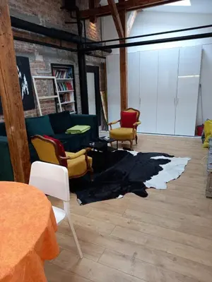 a living room with a couch and chairs and a rug at Brickloft in the heart of Belgrade in Belgrade