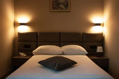 a bedroom with a large bed with two pillows at Garni hotel FILIA in Nova Pazova