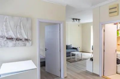 a living room with a couch and a painting on the wall at Dixy apartman in Belgrade
