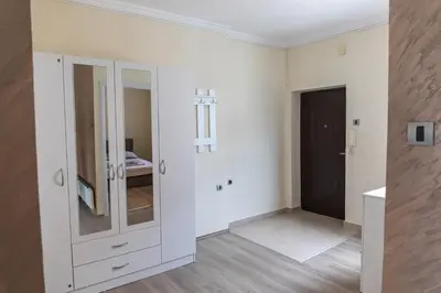 a bathroom with white cabinets and a mirror at Dixy apartman in Belgrade