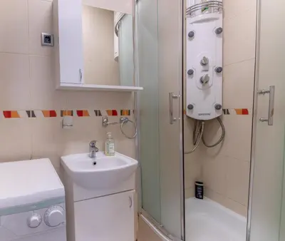 a small bathroom with a sink and a shower at Dixy apartman in Belgrade