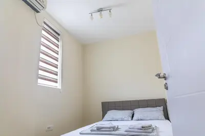 a bedroom with a bed with towels on it at Dixy apartman in Belgrade