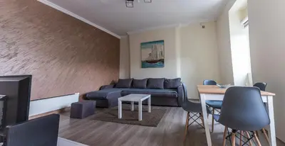 a living room with a couch and a table at Dixy apartman in Belgrade