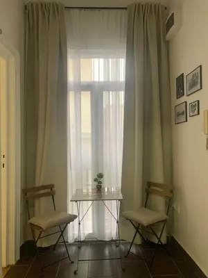 a table and two chairs in front of a window at Old Town City Center in Belgrade