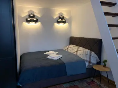 a bedroom with a bed with two towels on it at Old Town City Center in Belgrade