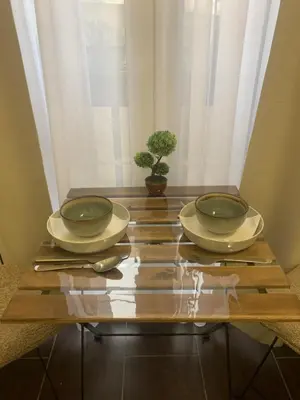 a wooden table with two plates and a plant on it at Old Town City Center in Belgrade