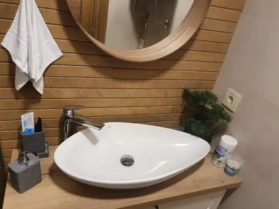 a white sink in a bathroom with a mirror at Apartment My Home in Belgrade