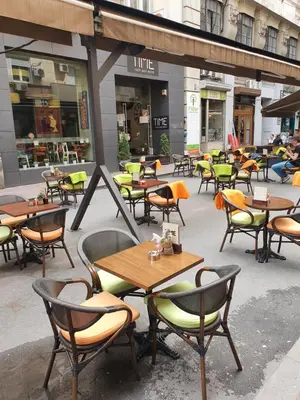 a group of tables and chairs on a patio at Apartment My Home in Belgrade